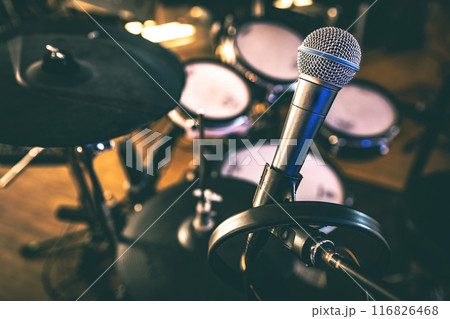 Microphone and drums in recording studio for live music perfomance. Mic for rock and pop vocal presentation 116826468