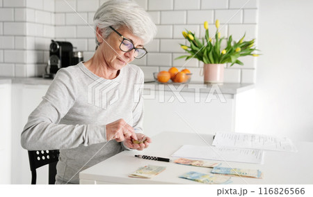 Elderly Lady Tallying Cash And Coins For Utility Bill Payments 116826566