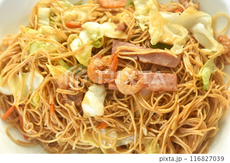 stir fried Hong Kong noodles cabbage and meat with slice bacon topping dry shrimp on plate 116827039