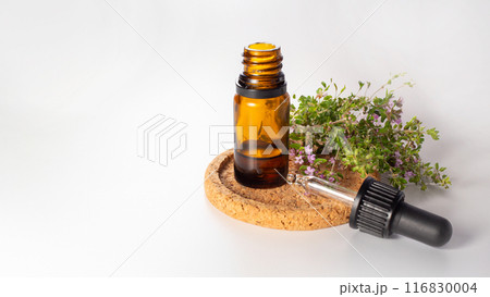Fresh thyme and essential oil isolated on the white background. Hair treatment concept. Close up. Copy space 116830004