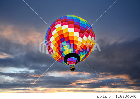 Colorful hot air balloon flying at sunset Colorful hot air balloon flying at sunset 116830040