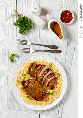 Chicken Lazone with sauce and linguine on plate Chicken Lazone with sauce and linguine on plate 116830892