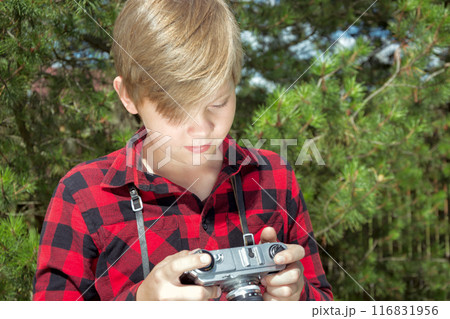 Teenager study and taking photos in the public park. Outdoors. Close up. Summer. 116831956