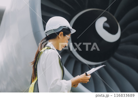 Technician fixing the engine of the airplane,Female aerospace engineering checking aircraft engines,Asian mechanic maintenance inspects plane engine 116833689
