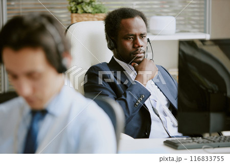 African American male worker dressed in business clothes plunged into his own thought during work day 116833755
