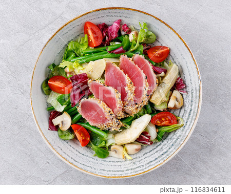 Tuna salad on a gray background. Nicoise salad, for restaurant menu for delivery Tuna salad on a gray background. Nicoise salad, for restaurant menu for delivery 116834611