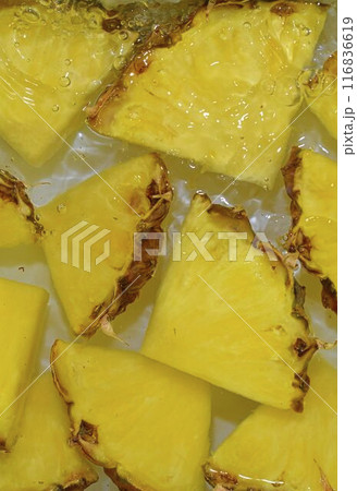 Close up view of the yellow pineapple slices in lemonade background. Texture of cooling sweet summer's drink with macro bubbles on the white background. Flat design. Vertical image Close up view of the yellow pineapple slices in lemonade background. Texture of cooling sweet summer's drink with macro bubbles on the white background. Flat design. Vertical image 116836619