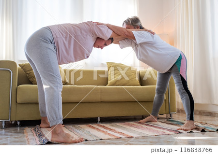 Senior woman exercising at home together with daughter.  116838766