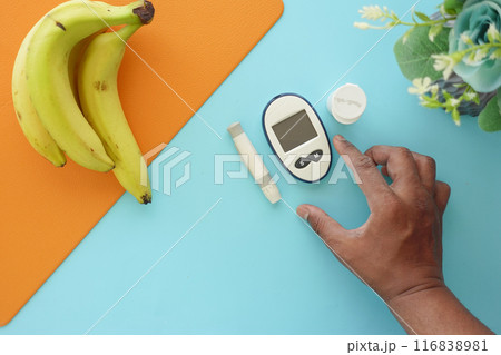 top vie of diabetic measurement tools and banana on a table top vie of diabetic measurement tools and banana on a table 116838981