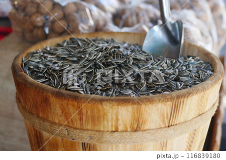 Sunflower seeds at a market stall lure customers seeking natural, organic, and gourmet ingredients Sunflower seeds at a market stall lure customers seeking natural, organic, and gourmet ingredients 116839180