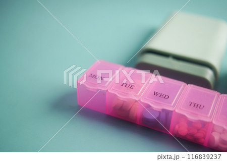 close up of medical pills in a pill box on table  116839237