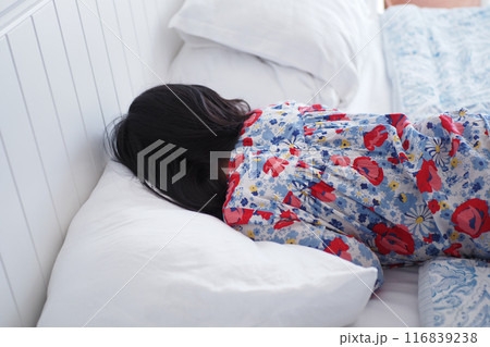 a child sleeping on bed a child sleeping on bed 116839238