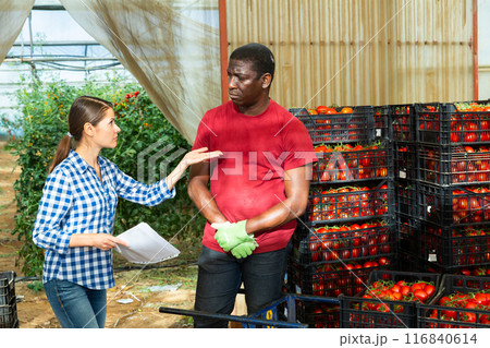 Two garden workers berating in warehouse Two garden workers berating in warehouse 116840614