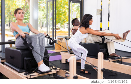 Positive woman and African American man training with female instructor Positive woman and African American man training with female instructor 116841161