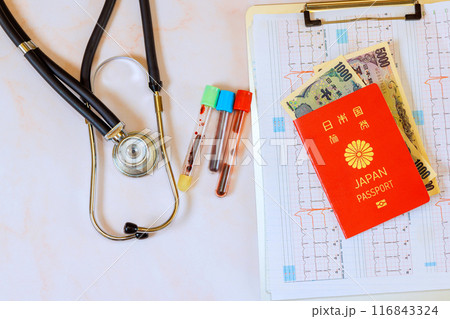 Medical care in Japan is expensive, with stethoscopes an electrocardiograms ECGs heart with Japanese passport, using Japanese yen 116843324