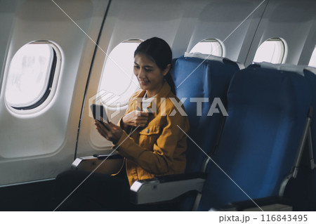 Texting on mobile chat app, Thoughtful asian people female person onboard, airplane window, perfectly capture the anticipation and excitement of holiday travel. chinese, japanese people. 116843495