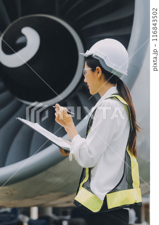 Technician fixing the engine of the airplane,Female aerospace engineering checking aircraft engines,Asian mechanic maintenance inspects plane engine 116843502