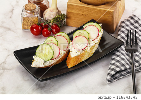 Bruschetta with soft cheese and radishes 116843545