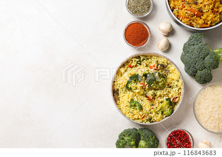 Pilaf in bowls, rice, spice and vegetables on white background, space for text 116843683