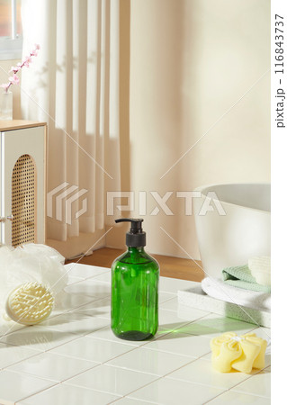Hygiene product advertising pic was taken in japanese bathroom, a white bath tub having a wooden tray above, which containing some bathing necessities, behind is a window with peach blossom outside 116843737