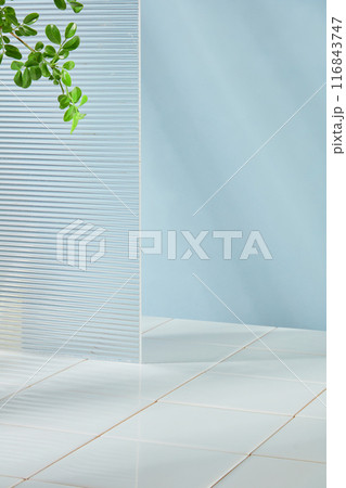 The photography of minimalist style bathroom with blue background and white brick floor. Plenty spaces for product advertisement and adding elements of designing 116843747
