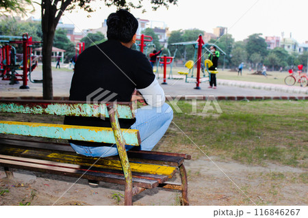 A picture of young boy sitting on chair with facing away from the camera A picture of young boy sitting on chair with facing away from the camera 116846267