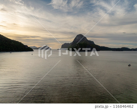 Island and boats under blue sky and clouds. El Nido, Palawan. Philippines. Island and boats under blue sky and clouds. El Nido, Palawan. Philippines. 116846462