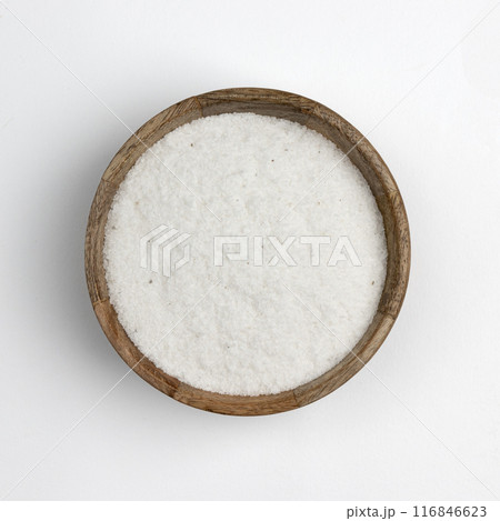 white sea salt in a wooden bowl isolated on white 116846623