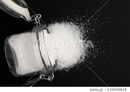 white sea salt in glass jar isolated on black 116846628