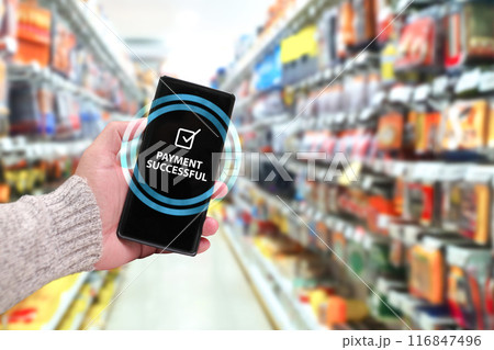 Paying for goods with a mobile phone in department stores , Hand holding a smartphone to pay Paying for goods with a mobile phone in department stores , Hand holding a smartphone to pay 116847496