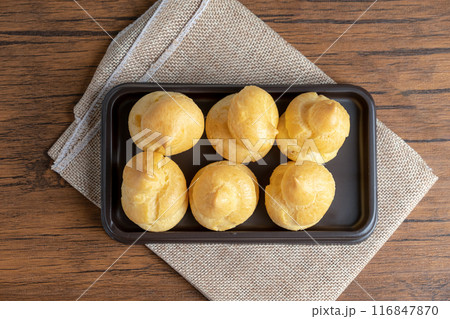 Eclairs on brown plastic trays for sale 116847870