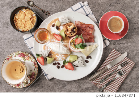 Beautiful western breakfast on a white plate with a hot drink for an energetic breakfast. 116847871