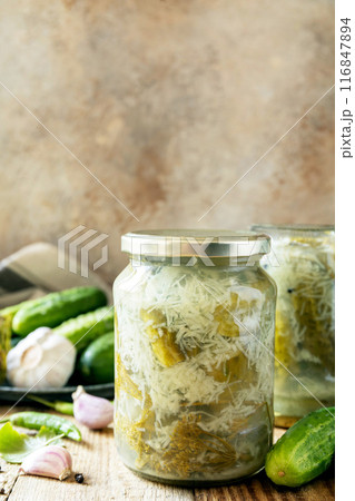 Healthy homemade fermented food. Salted pickled cucumbers with garlic, preserved canned in glass jar. Home economics, autumn harvest preservation. Copy space. Healthy homemade fermented food. Salted pickled cucumbers with garlic, preserved canned in glass jar. Home economics, autumn harvest preservation. Copy space. 116847894
