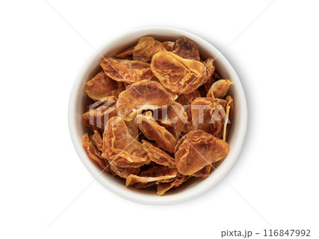 Bowl with dried sweet tangerine mandarine bites isolated on white background. 116847992