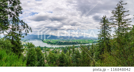 View of the Mission town with Fraser River, lush green valley and the mountains in the background - Fraser Valley, BC, Canada View of the Mission town with Fraser River, lush green valley and the mountains in the background - Fraser Valley, BC, Canada 116848042