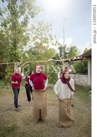 A group of people are playing a game of sack race 116850851