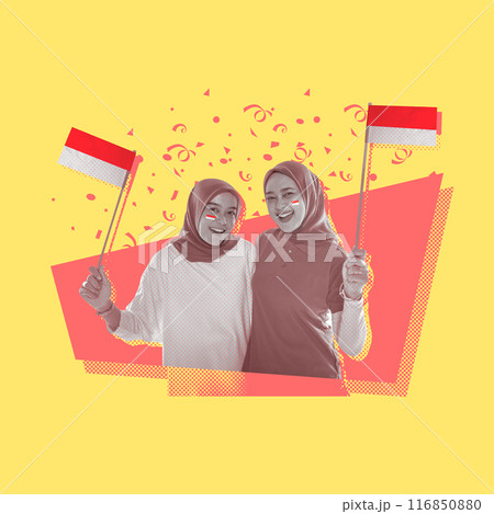 Portrait of two women with excited expressions holding small Indonesian flags 116850880