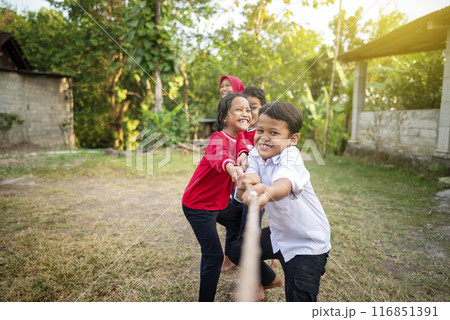 Portrait of Indonesian kids celebrate Indonesia Independence Day with traditional events like a tug of war contest 116851391