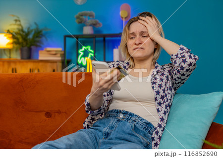 Angry stressed woman trying to pay online shopping with smartphone blocked credit card smartphone Angry stressed woman trying to pay online shopping with smartphone blocked credit card smartphone 116852690