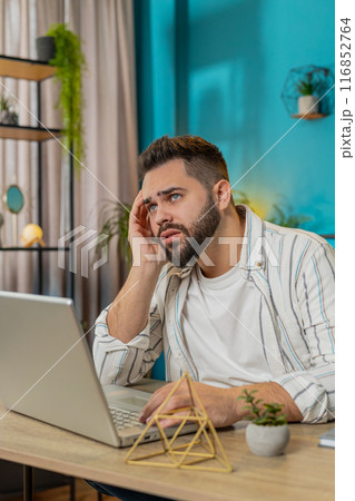 Sad frustrated pensive annoyed man suffers from unfair situation bankruptcy stress at home office Sad frustrated pensive annoyed man suffers from unfair situation bankruptcy stress at home office 116852764