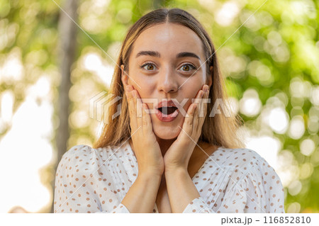 Woman looking surprised at camera with big open eyes, shocked by sudden victory good news wow win 116852810