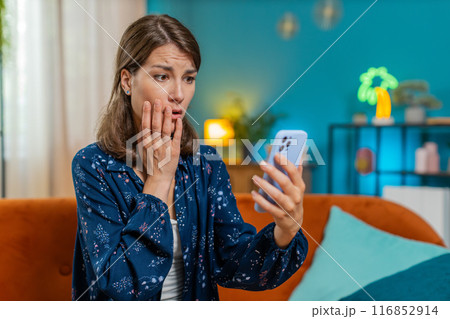 Sad displeased Caucasian woman using smartphone receive bad news, fortune loss fail, deadline, virus Sad displeased Caucasian woman using smartphone receive bad news, fortune loss fail, deadline, virus 116852914