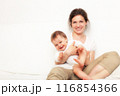 Mother playing with baby on white 116854366