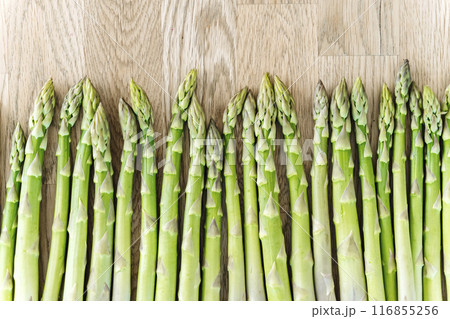 Asparagus on the table. Fresh farm vegetable asparagus on the kitchen table before cooking. Vegan, eco-friendly Asparagus on the table. Fresh farm vegetable asparagus on the kitchen table before cooking. Vegan, eco-friendly 116855256