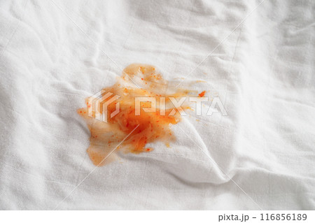 Dirty spicy sauce stain on cloth to wash with washing powder, cleaning housework concept. 116856189