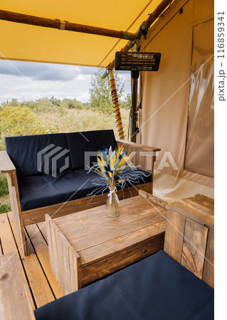 Interior of cozy open glamping tent. Camping tent for outdoor summer holiday and vacation Interior of cozy open glamping tent. Camping tent for outdoor summer holiday and vacation 116859341