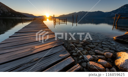 Sunset Over Wooden Dock on Calm Lake 116859625