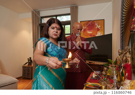 Couple Praying At Altar At Home 116860746