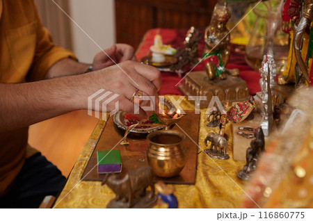 Man Lightning Candles At Altar Man Lightning Candles At Altar 116860775