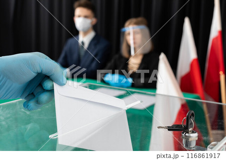 The young voter throws into the ballot box his votes for the new candidate for the new president of Poland. 116861917